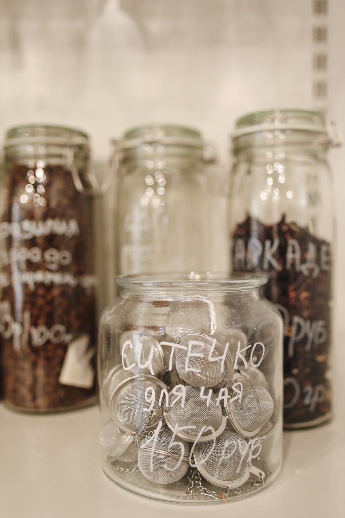 services-04 A variety of eco-friendly glass jars displayed in a zero waste store emphasizing sustainable shopping.