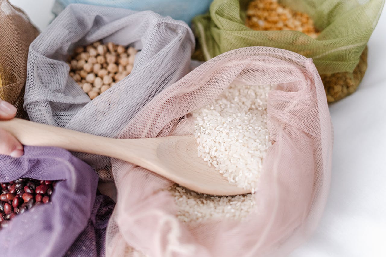 our-story Close-up of eco-friendly reusable bags filled with various grains, promoting zero waste lifestyle.